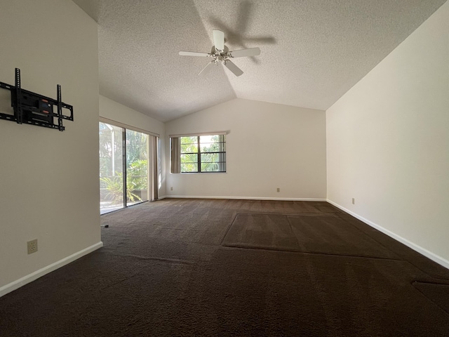 unfurnished room featuring carpet, a textured ceiling, ceiling fan, and lofted ceiling