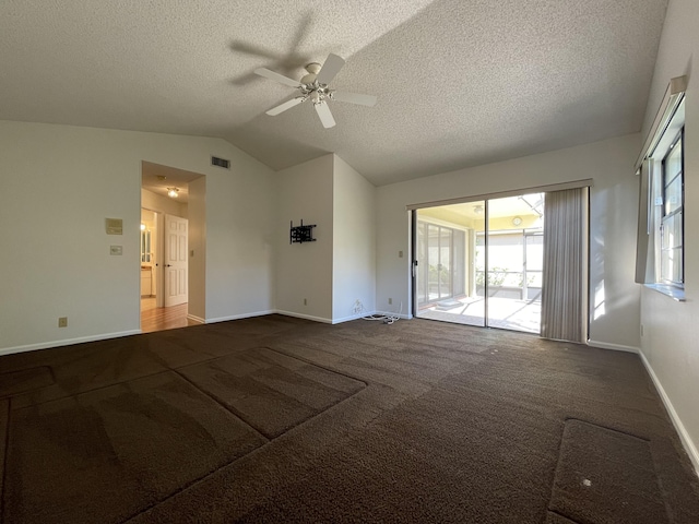 carpeted empty room featuring a textured ceiling, ceiling fan, and lofted ceiling