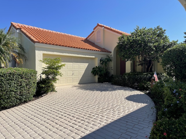 mediterranean / spanish-style home with a garage