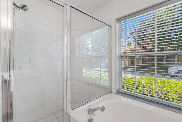 bathroom featuring separate shower and tub