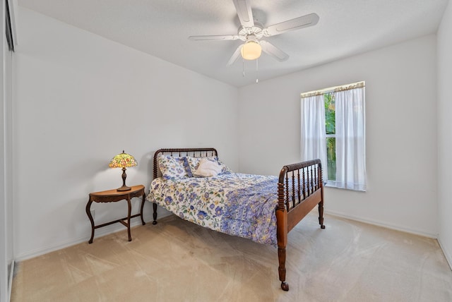 bedroom featuring ceiling fan and light carpet