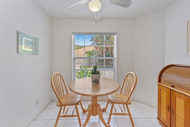 tiled dining area featuring ceiling fan