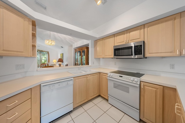 kitchen with light brown cabinetry, white appliances, and an inviting chandelier