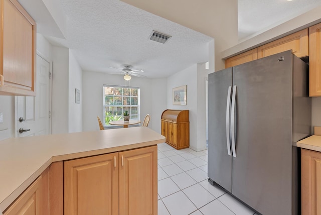 kitchen featuring light brown cabinets, ceiling fan, light tile patterned floors, kitchen peninsula, and stainless steel refrigerator