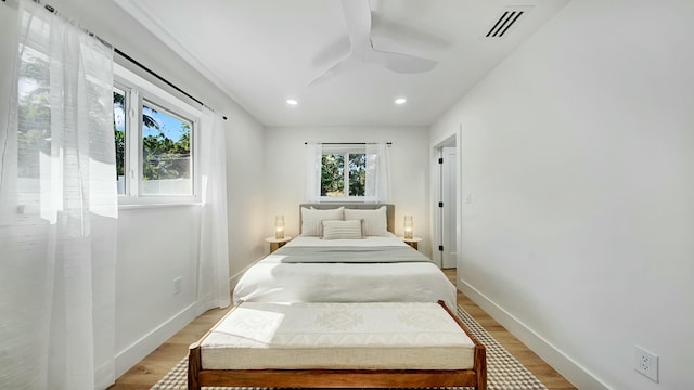 bedroom with light hardwood / wood-style floors and ceiling fan