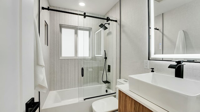 full bathroom with shower / bath combination with glass door, vanity, and toilet