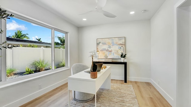 office with ceiling fan and light hardwood / wood-style floors