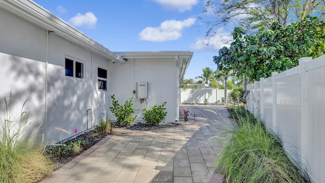 view of side of home with a patio area