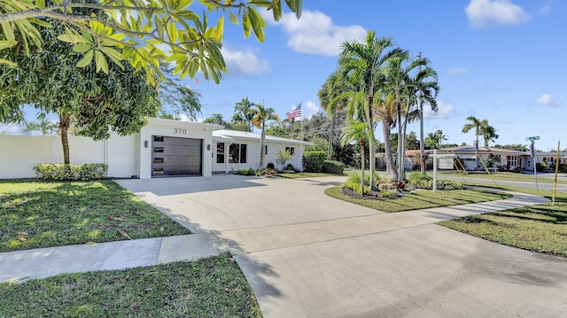 view of front of property with a garage and a front yard