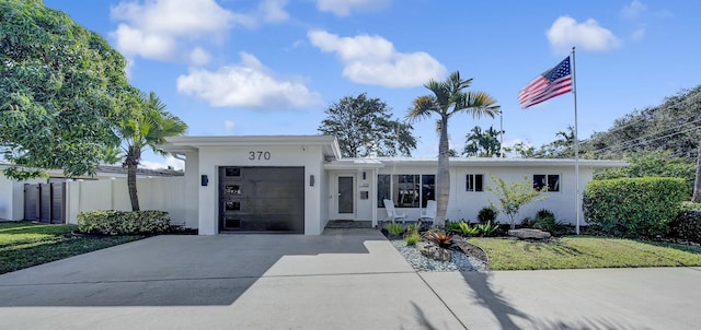 view of front of house featuring a garage and a front lawn