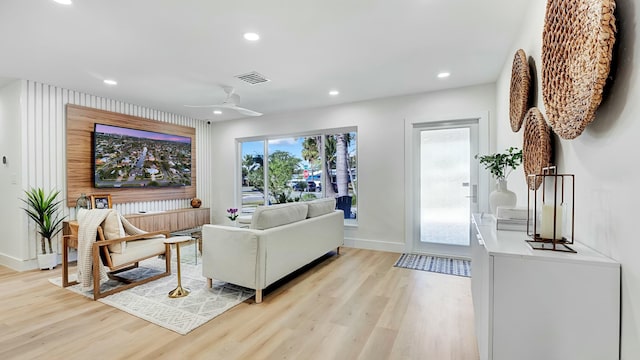 living room featuring ceiling fan and light hardwood / wood-style flooring