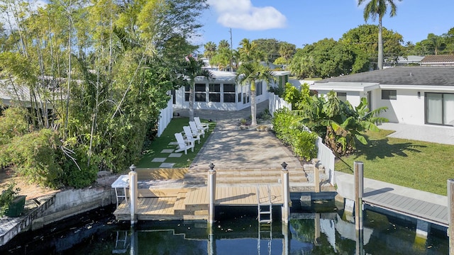 view of dock with a lawn