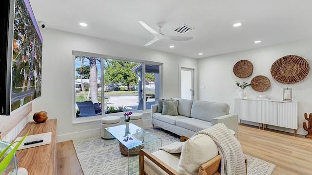 living room with ceiling fan and light wood-type flooring