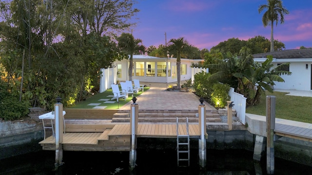 dock area featuring a patio area and a lawn