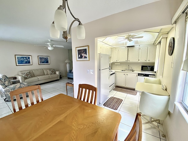 tiled dining space with a notable chandelier and sink