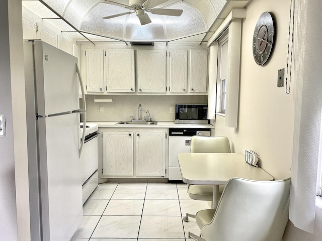 kitchen with white appliances, sink, ceiling fan, light tile patterned floors, and tasteful backsplash