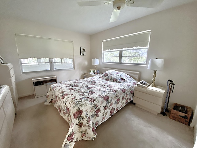 bedroom with a wall mounted AC and ceiling fan