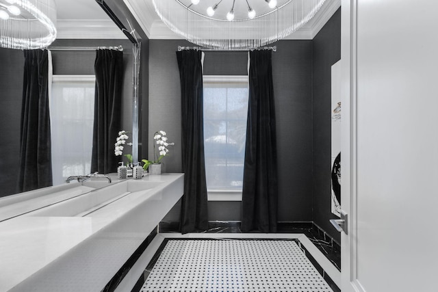 bathroom with crown molding and an inviting chandelier