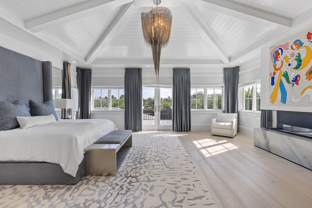 bedroom with an inviting chandelier, french doors, and light hardwood / wood-style flooring