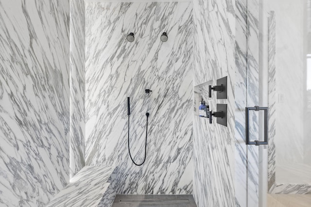 interior details featuring a tile shower