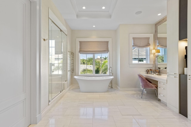 bathroom with a raised ceiling, vanity, and separate shower and tub