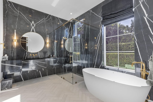 bathroom with tile walls and plus walk in shower