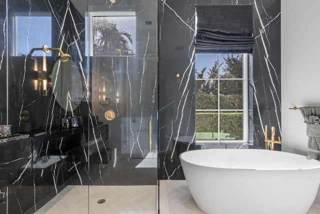 bathroom featuring parquet flooring, independent shower and bath, and a healthy amount of sunlight