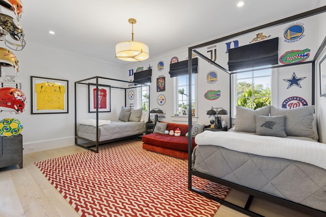 bedroom featuring crown molding and wood-type flooring