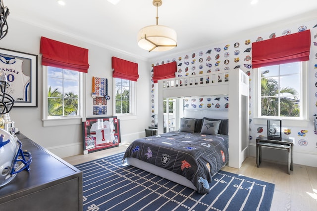 bedroom with hardwood / wood-style flooring and ornamental molding