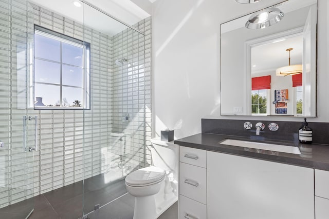 bathroom with tile patterned flooring, vanity, toilet, and a shower with shower door