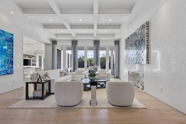 living room featuring beamed ceiling, french doors, light hardwood / wood-style flooring, and coffered ceiling