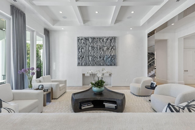 living room featuring beamed ceiling, light hardwood / wood-style floors, and coffered ceiling