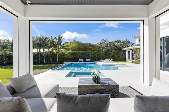 view of pool with an in ground hot tub and a patio