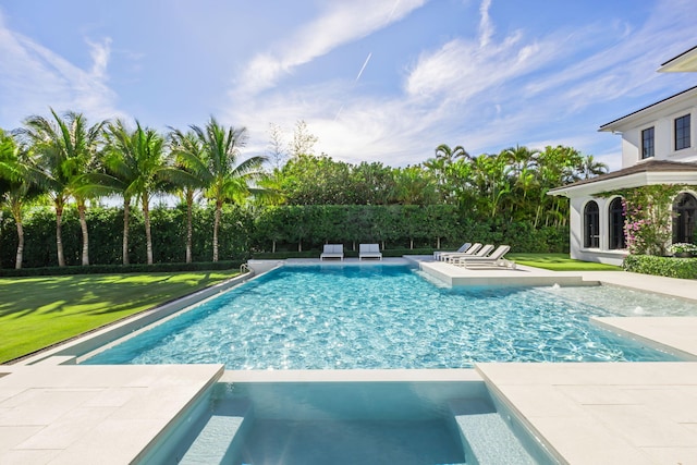 view of swimming pool with an in ground hot tub and a lawn