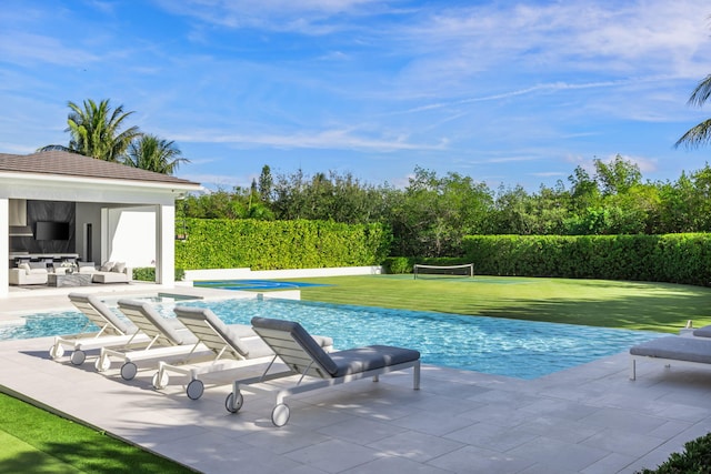 view of pool featuring a lawn and a patio area