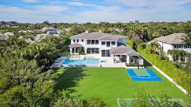 rear view of house with a patio and basketball court