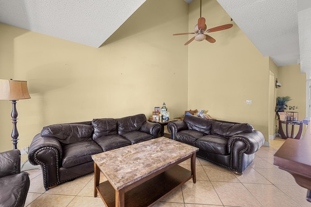 tiled living room featuring ceiling fan, high vaulted ceiling, and a textured ceiling