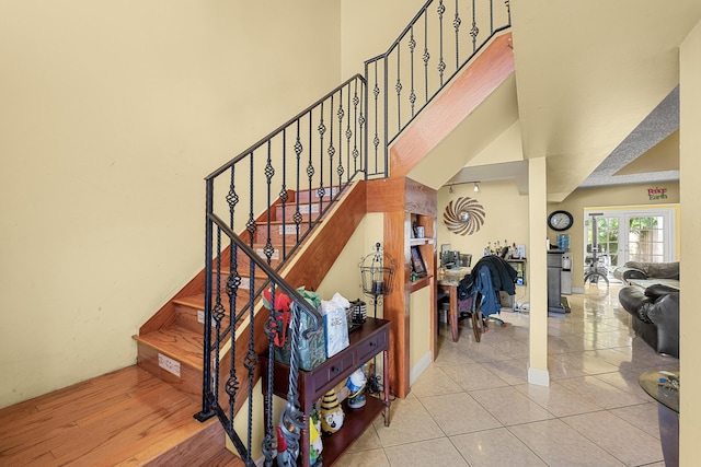 staircase featuring tile patterned floors and french doors