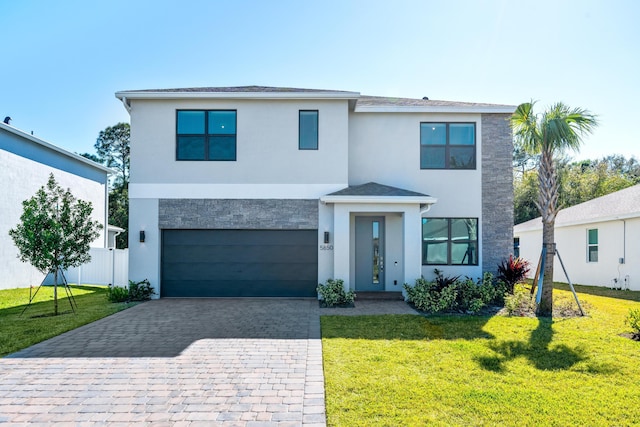 view of front of home featuring a front yard and a garage