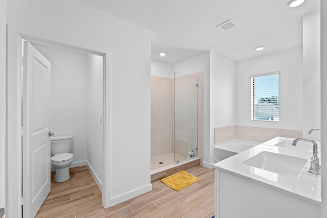 full bathroom featuring shower with separate bathtub, vanity, and toilet