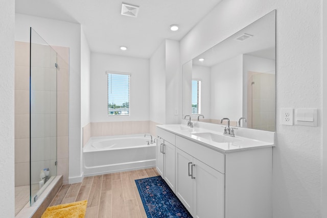 bathroom featuring separate shower and tub and vanity