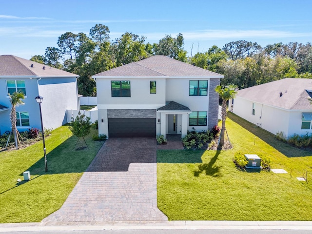 view of front of house with a garage and a front lawn