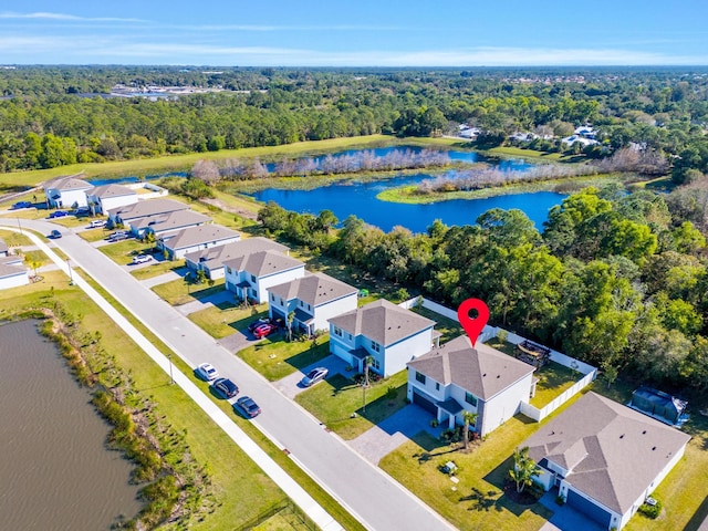 birds eye view of property with a water view