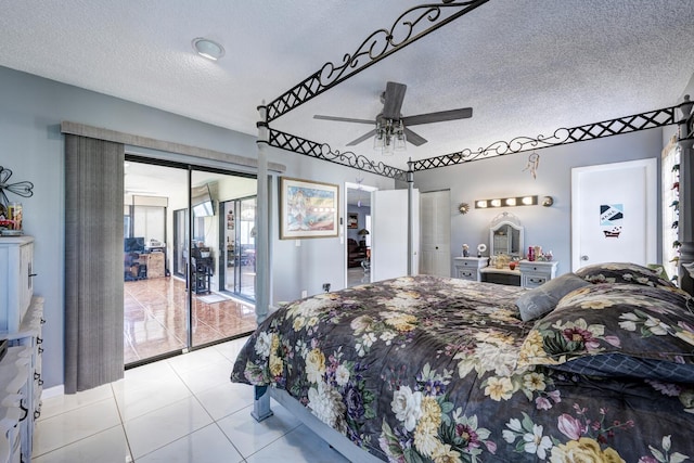 tiled bedroom featuring access to outside, ceiling fan, and a textured ceiling