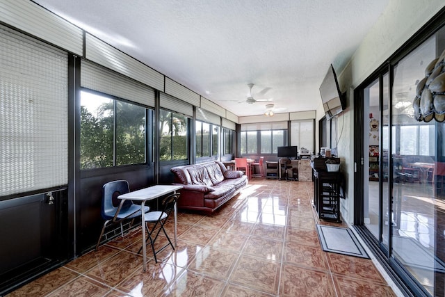 sunroom / solarium featuring ceiling fan