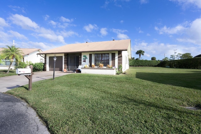 view of front of home with a front yard and a garage