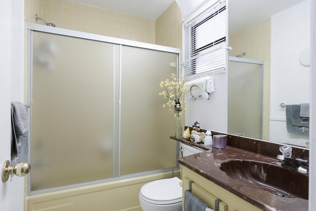 full bathroom with shower / bath combination with glass door, vanity, and toilet