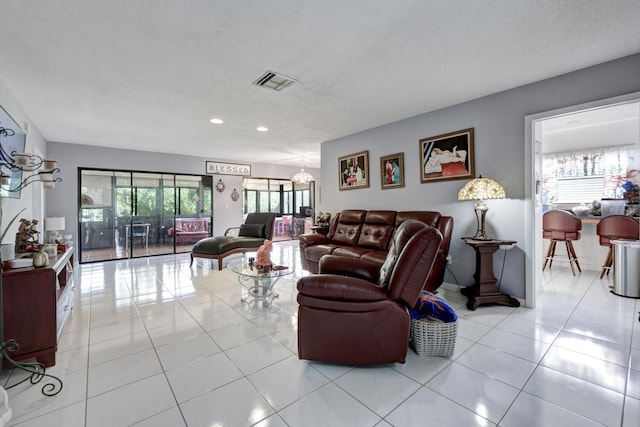 living room featuring a textured ceiling and light tile patterned flooring