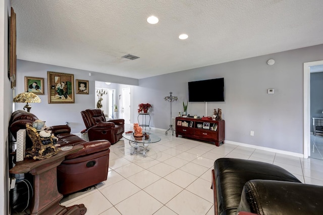 tiled living room featuring a textured ceiling