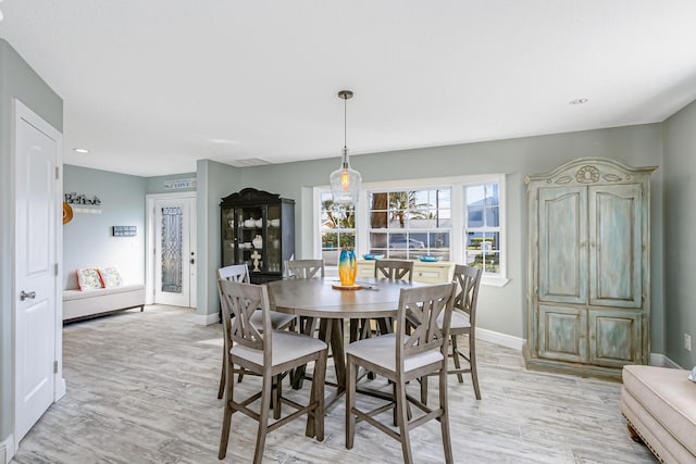 dining space with light hardwood / wood-style floors